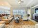 Spacious living room with hardwood floors, a ceiling fan, and views of the pool at 13422 Niti Dr, Hudson, FL 34669