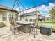 Outdoor bar and patio area with ample seating and screened-in enclosure at 13422 Niti Dr, Hudson, FL 34669