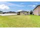 Spacious backyard featuring a well-maintained lawn, enclosed by a white fence for privacy at 13454 Graham Yarden Dr, Riverview, FL 33579