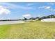 Expansive lawn slopes toward a serene lake, perfect for outdoor enjoyment and scenic views at 13454 Graham Yarden Dr, Riverview, FL 33579