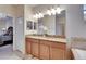 Bathroom featuring double vanity with granite countertops, undermount sinks, and large mirror at 13454 Graham Yarden Dr, Riverview, FL 33579