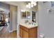 Bathroom featuring a light wood vanity, white countertop, and a large mirror at 13454 Graham Yarden Dr, Riverview, FL 33579