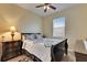 Bedroom with a black-and-white patterned bedspread and a dark wood nightstand with a lamp at 13454 Graham Yarden Dr, Riverview, FL 33579