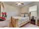 Bedroom featuring a bed with a gold-and-yellow patterned bedspread and a nightstand with a lamp at 13454 Graham Yarden Dr, Riverview, FL 33579