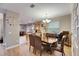 Bright dining area with an adjacent open kitchen, stylish lighting and a kitchen bar at 13454 Graham Yarden Dr, Riverview, FL 33579