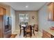 Eat-in kitchen area features stainless steel refrigerator and cabinet space at 13454 Graham Yarden Dr, Riverview, FL 33579