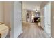 Bright entryway featuring wood-look floors, white trim, and an open view into the living area at 13454 Graham Yarden Dr, Riverview, FL 33579