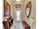 Inviting foyer featuring elegant décor, a decorative mirror, and stylish furnishings at 13454 Graham Yarden Dr, Riverview, FL 33579