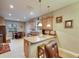 Open kitchen features granite counters, light wood cabinets, island with seating, and stainless steel appliances at 13454 Graham Yarden Dr, Riverview, FL 33579