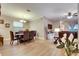 Open-concept living and dining area with wood-look floors, modern decor, and abundant natural light at 13454 Graham Yarden Dr, Riverview, FL 33579