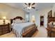 Spacious main bedroom with a ceiling fan, bedside table, and access to the en-suite bath and walk-in closet at 13454 Graham Yarden Dr, Riverview, FL 33579