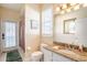 Bright bathroom featuring a granite vanity top, a toilet, and a shower with access to the patio at 13712 Trinity Leaf Pl, Riverview, FL 33579