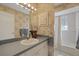 Well-lit bathroom features a sink, storage, and a tub with a glass block window, providing natural light at 14019 Briardale Ln, Tampa, FL 33618