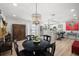 Elegant dining room with modern lighting, adjacent to kitchen and entryway, with wood-look flooring at 14265 Page Ave, Largo, FL 33774