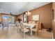 Formal dining room with a chandelier, six chairs, tile flooring, and an amazing view at 16023 Golden Lakes Dr, Wimauma, FL 33598