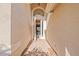 Charming entryway with brick flooring, a brightly lit white door, and a glimpse into the home at 16023 Golden Lakes Dr, Wimauma, FL 33598