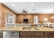 Kitchen features a double sink, granite countertops, stainless steel appliances, and a view of dining and living areas at 16023 Golden Lakes Dr, Wimauma, FL 33598