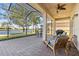 This covered lanai features brick pavers, comfortable seating, and tranquil lake views at 16023 Golden Lakes Dr, Wimauma, FL 33598
