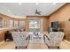Bright living room featuring tile floors, comfortable seating, and serene views of the lake at 16023 Golden Lakes Dr, Wimauma, FL 33598