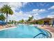 Beautiful swimming pool with plenty of seating and a view of the clubhouse at 16023 Golden Lakes Dr, Wimauma, FL 33598