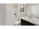 Bright bathroom featuring a shower-tub combination with white tile surround and a granite-topped vanity at 17048 James Trl, Parrish, FL 34219