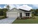 New construction home featuring a 2-car garage, stone accents and a landscaped yard at 17048 James Trl, Parrish, FL 34219