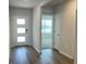 Inviting foyer with wood-look flooring and a modern front door at 17048 James Trl, Parrish, FL 34219