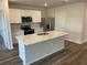 Modern kitchen featuring white cabinets, stainless appliances, and island at 17048 James Trl, Parrish, FL 34219