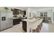 Modern kitchen featuring stainless steel appliances, an island with seating and dark wood cabinets at 17048 James Trl, Parrish, FL 34219