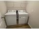 Laundry room featuring a side-by-side washer and dryer with wire shelving at 17048 James Trl, Parrish, FL 34219