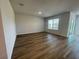 Open living space with wood-look flooring and ample natural light at 17048 James Trl, Parrish, FL 34219