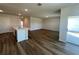 Open-concept living area with kitchen island and sliding glass doors at 17048 James Trl, Parrish, FL 34219