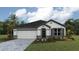 Charming single-Gathering home with a well-manicured lawn, two-car garage, and neutral-colored trim at 17056 James Trl, Parrish, FL 34219