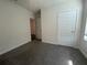 An empty bedroom features neutral paint and gray carpet with a modern white door at 17205 Barnwood Pl, Bradenton, FL 34211