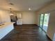 Dining area with wood-look floors, modern lighting, and a sliding glass door to the outside at 17205 Barnwood Pl, Bradenton, FL 34211