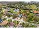 Aerial shot of the home with red outline, positioned in a neighborhood with surrounding trees and pond at 17508 Isbell Ln, Odessa, FL 33556