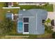 Overhead view featuring a house with a swimming pool and solar panels, next to detached garage at 17508 Isbell Ln, Odessa, FL 33556