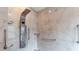 Modern shower with multi-setting shower head and marble-style tile at 17508 Isbell Ln, Odessa, FL 33556
