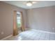 Clean and bright bedroom with tile flooring and a window that filters in natural light at 17508 Isbell Ln, Odessa, FL 33556