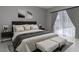 Comfortable bedroom with a large bed, modern decor, and sliding glass doors to the outside at 17508 Isbell Ln, Odessa, FL 33556