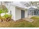 Detached one-car garage with gray door and white walls, adjacent to the home's backyard and pool area at 17508 Isbell Ln, Odessa, FL 33556