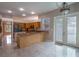 Bright kitchen area with marble floors, a breakfast bar, and outdoor access at 17508 Isbell Ln, Odessa, FL 33556