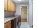 Well-organized laundry room with modern washer and dryer and upper storage cabinets at 17508 Isbell Ln, Odessa, FL 33556