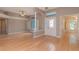 Open living room with wood floors, large windows, and natural light pouring through at 17508 Isbell Ln, Odessa, FL 33556