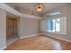 Bright living room with hardwood floors and a large window with shutters at 17508 Isbell Ln, Odessa, FL 33556