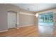 Living room with hardwood floors and sliding glass doors to the pool area at 17508 Isbell Ln, Odessa, FL 33556