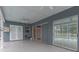 Covered patio featuring speckled flooring, ceiling fans, and sliding glass doors leading to the outdoors at 17508 Isbell Ln, Odessa, FL 33556