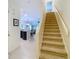 Bright foyer with staircase and open view into the kitchen and living area, promoting an airy feel at 20462 Needletree Dr, Tampa, FL 33647