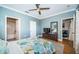 Cozy bedroom with hardwood floors, ensuite bathroom, and door leading to a seating area at 2138 Chianti Pl # 142, Palm Harbor, FL 34683