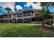 Stunning condominiums with lush green grass, a tiled roof, and stone accents at 2138 Chianti Pl # 142, Palm Harbor, FL 34683